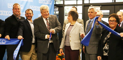 Mike Walsh, President and CEO, cutting ribbon at grand opening with local officials.