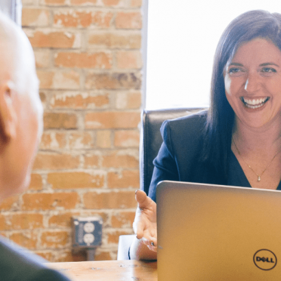 Senior Consultant - Project Coordinator image: two people are seated across each other at a table.